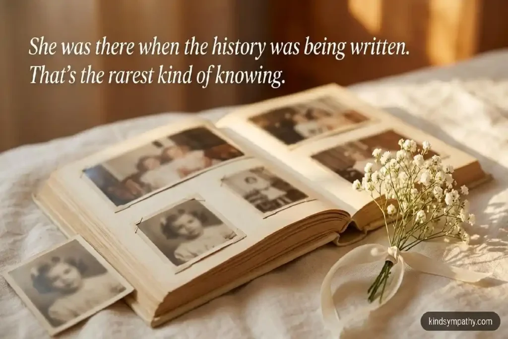 Old photo album with white baby's breath flowers — sympathy message for loss of sister