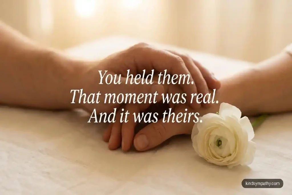Two hands held together with white flower — stillbirth condolence message — kindsympathy.com
